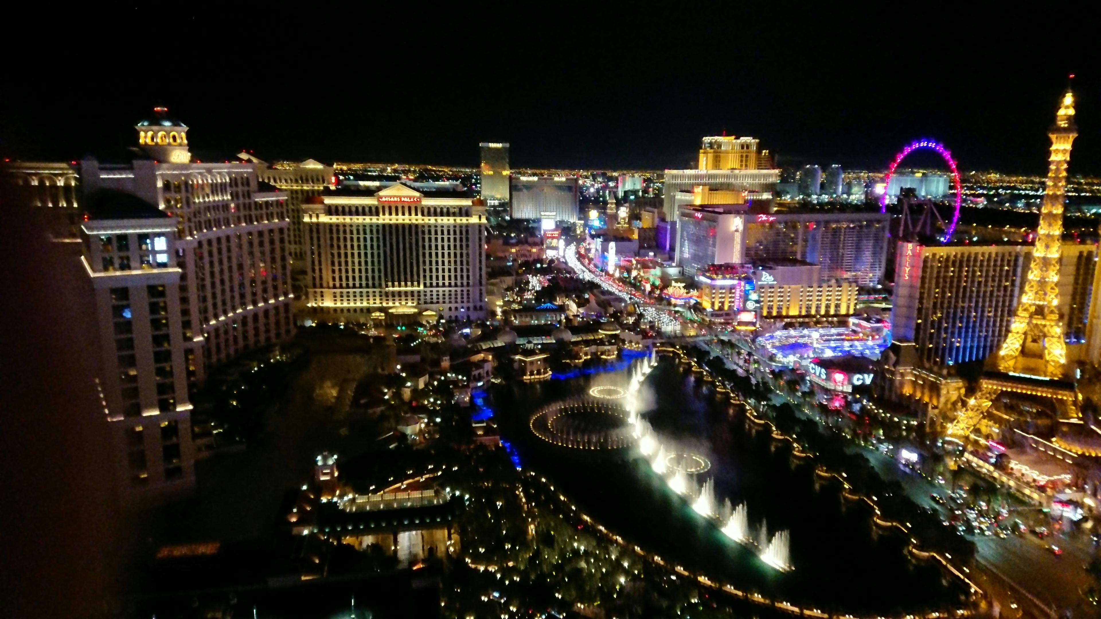 Aerial view of the Las Vegas Strip at night showing luxury vehicles and vibrant nightlife scene
