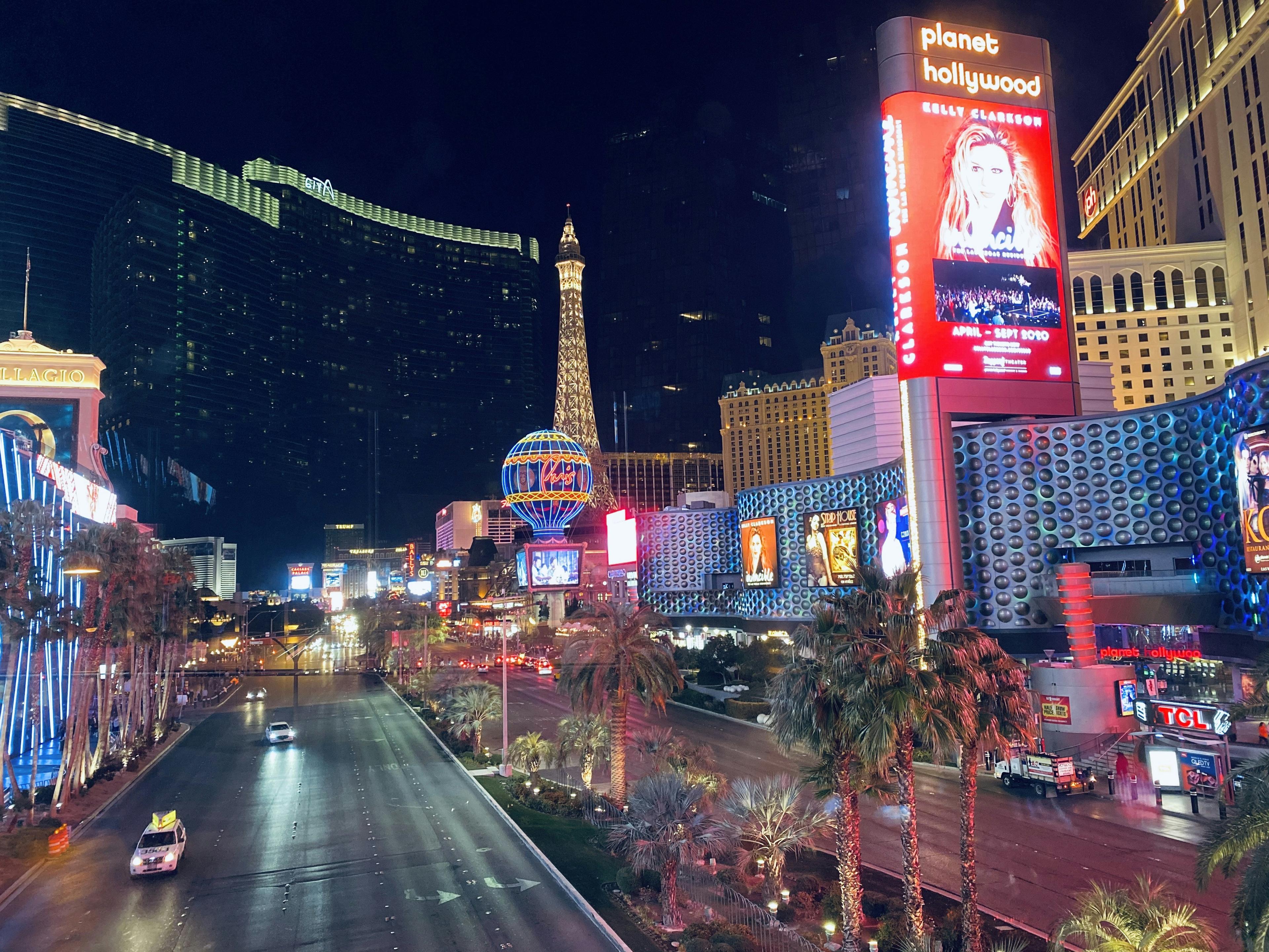 Private luxury SUV touring the Las Vegas Strip at night with iconic casino lights in the background