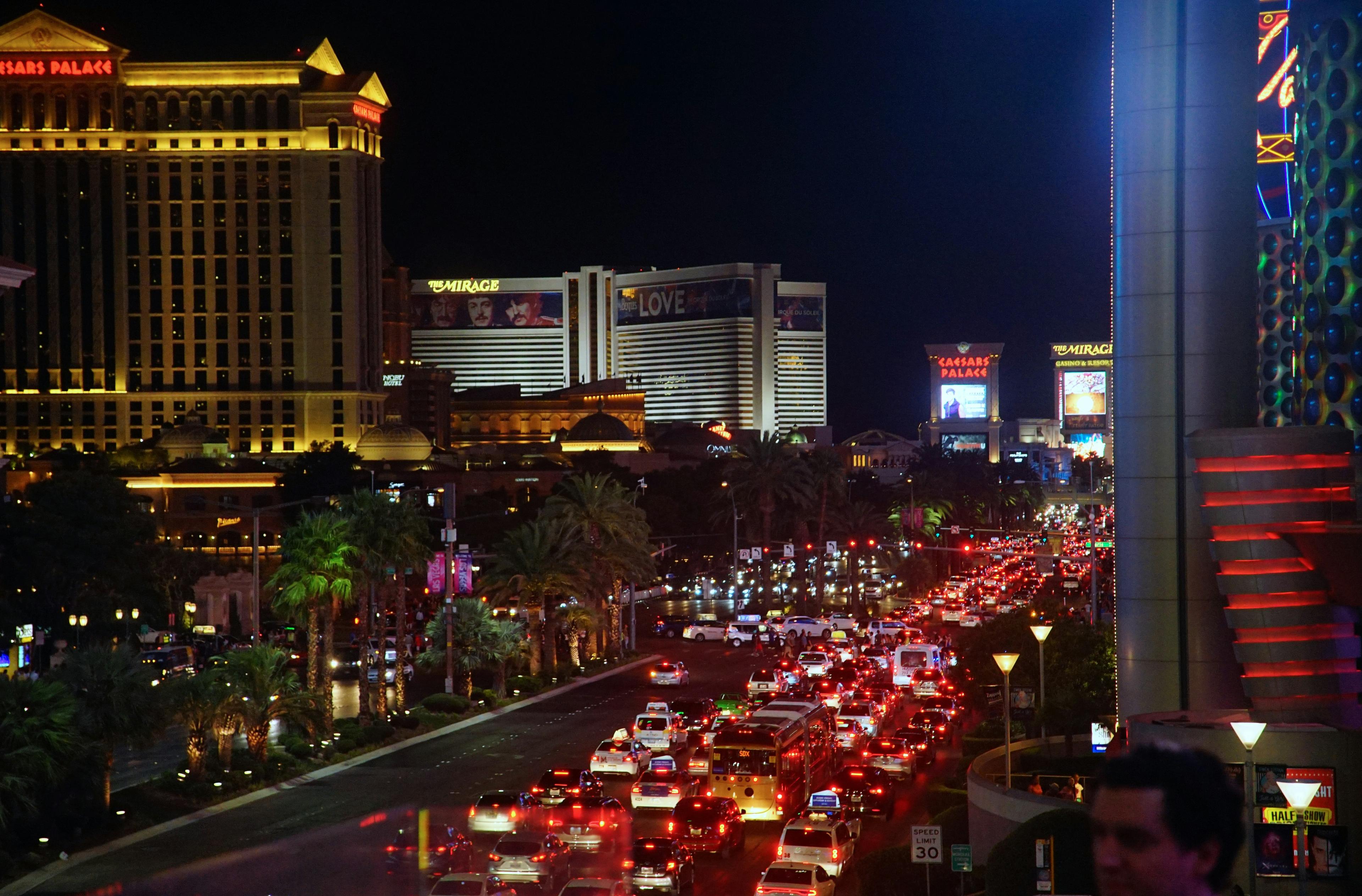Las Vegas Strip at night with luxury transportation vehicles and heavy traffic on the boulevard