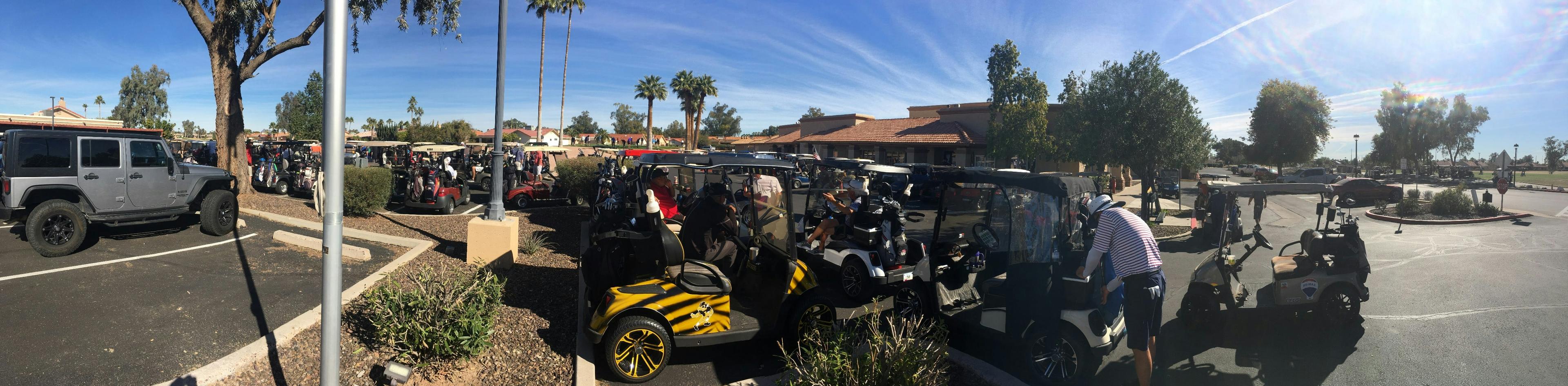 Luxury SUV parked at a Las Vegas golf course with golf bags being loaded by a chauffeur