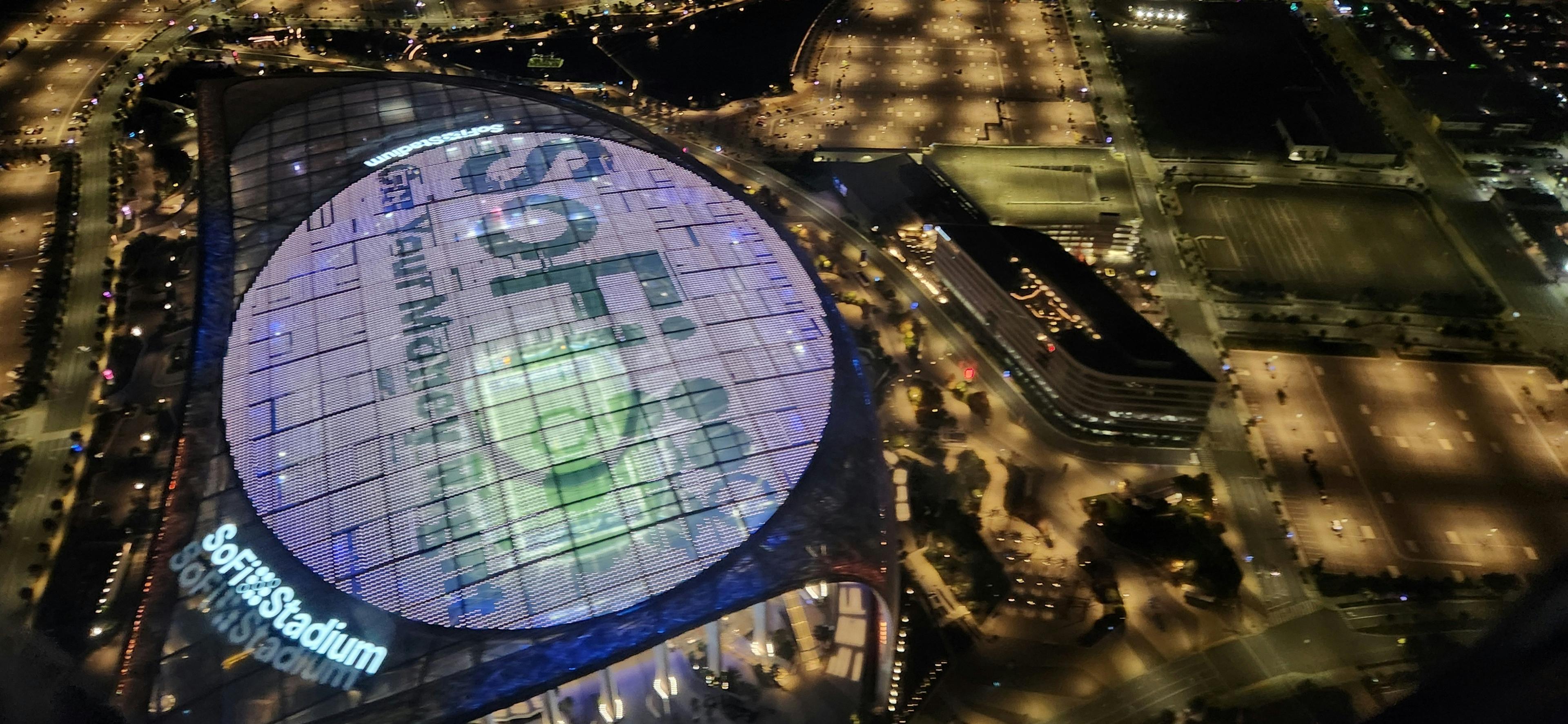 SoFi Stadium in Los Angeles lit up at night during a major international soccer match