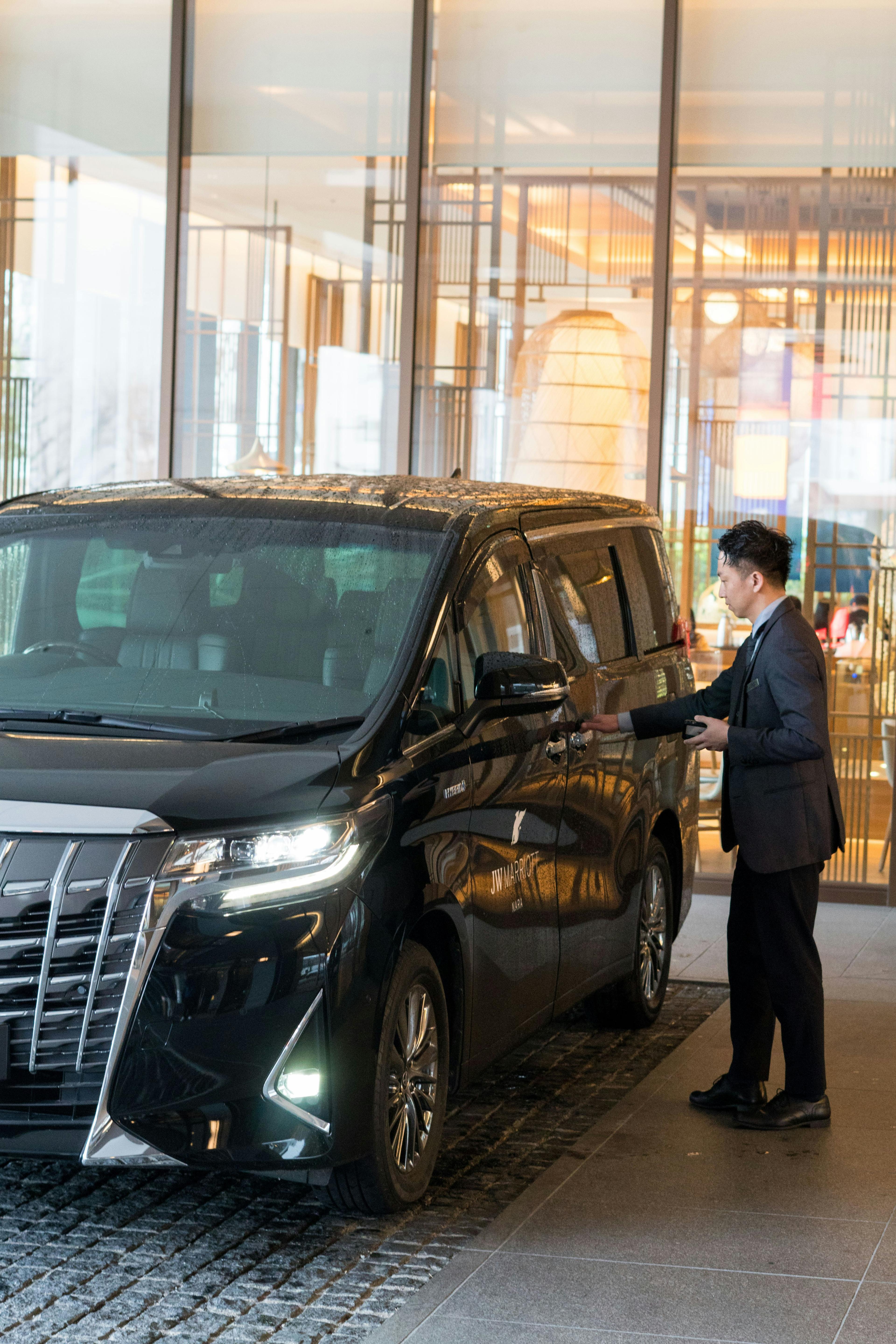 Luxury black sedan dropping off VIP guests at a Las Vegas casino entrance with valet service